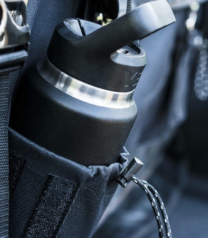 Close-up of a bottle holder attached to a bag in a vehicle